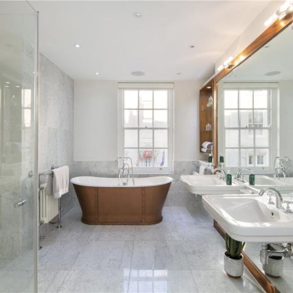 Beautiful bathroom with white painted walls and light grey titling