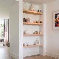 Thick wooden shelves with white walls