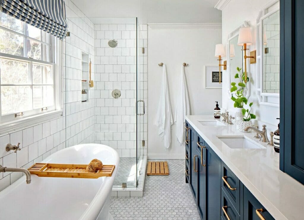 Newly renovated bathroom with blue cupboards and white tiling