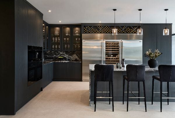 High-end blacked out kitchen with luxury marble and appliances