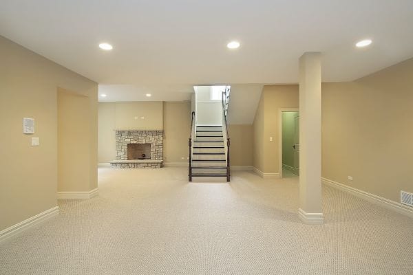 Basement conversion into open plan bedroom with fireplace